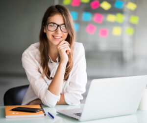 successful-businesswoman-working-on-laptop-computer-and-thinks-on-new-ideas-in-her-office-dressed-up-in-white-clothes