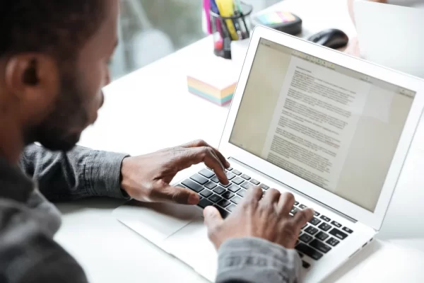 A man learning how to write an essay with legal English innovation.