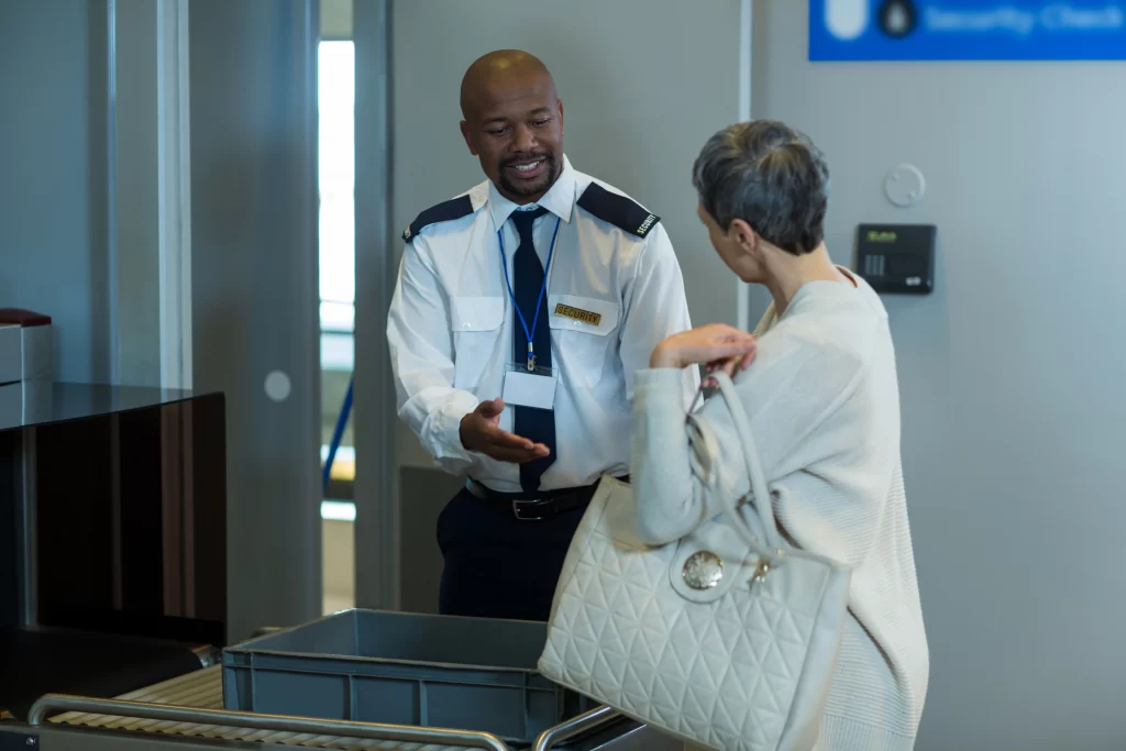 Man helping a woman to learn English in an airport